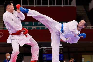 USA’s Tom Scott attempts to kick Japan’s Ken Nishimura during the karate men’s kumite -75kg...