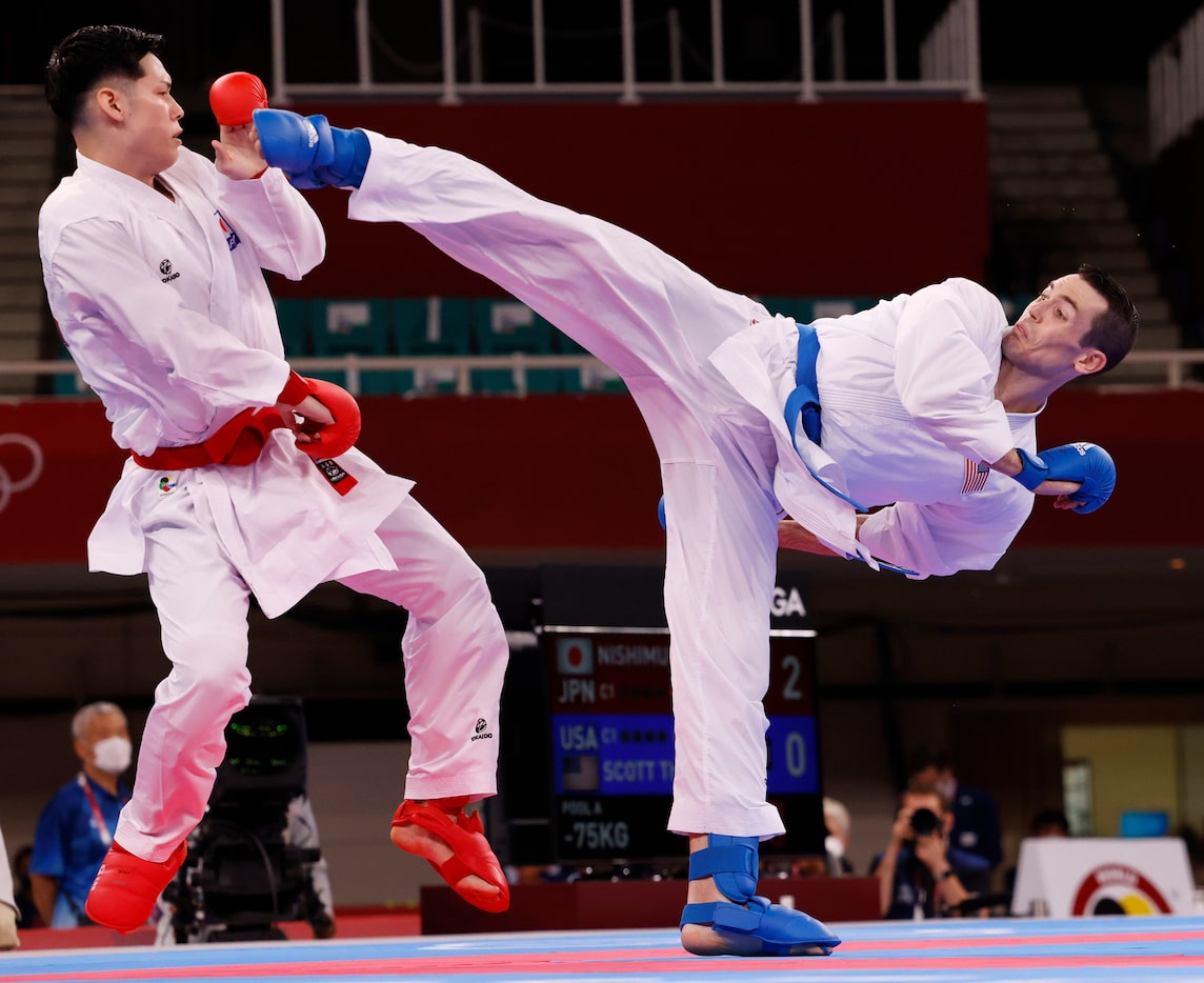 USA’s Tom Scott attempts to kick Japan’s Ken Nishimura during the karate men’s kumite -75kg...