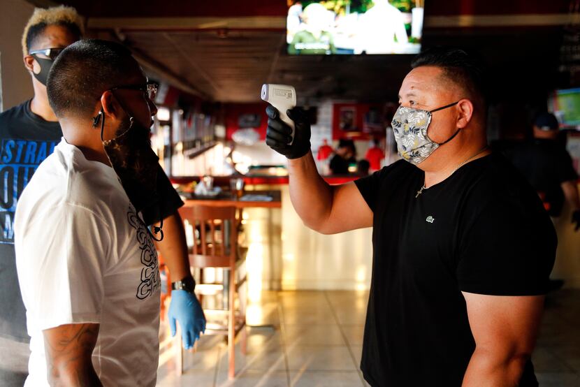 Operating partner Roy Ramos took the temperature of customers entering Mezcal Sports Bar and...
