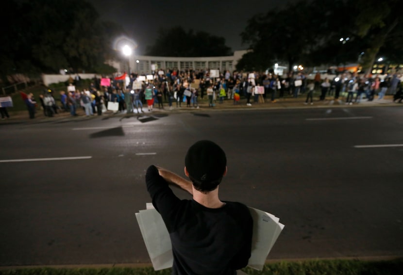 Trump supporter Patrick Connery stands across Elm Street as protesters against...