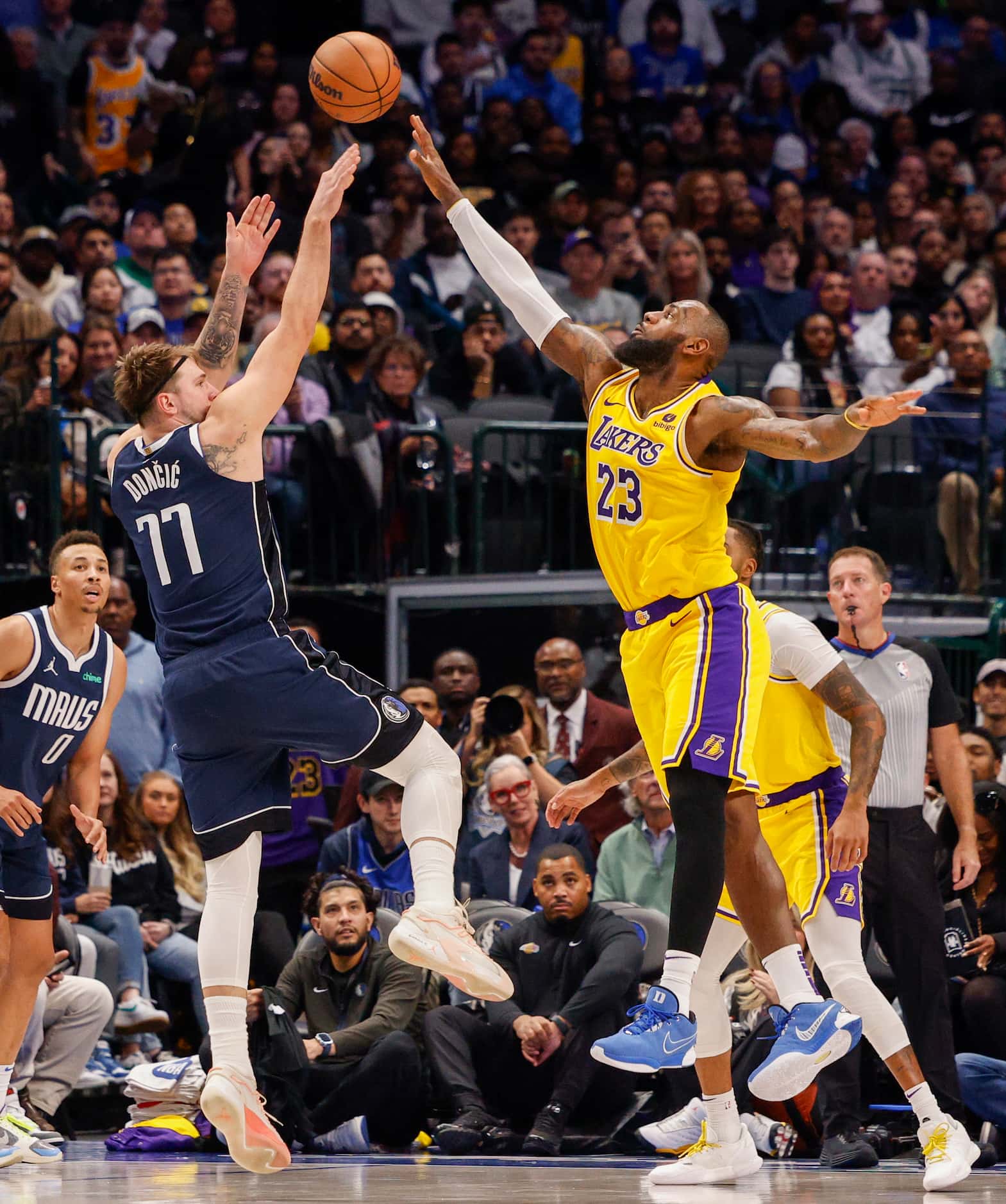 Dallas Mavericks guard Luka Doncic (77) shoots over Los Angeles Lakers forward LeBron James...