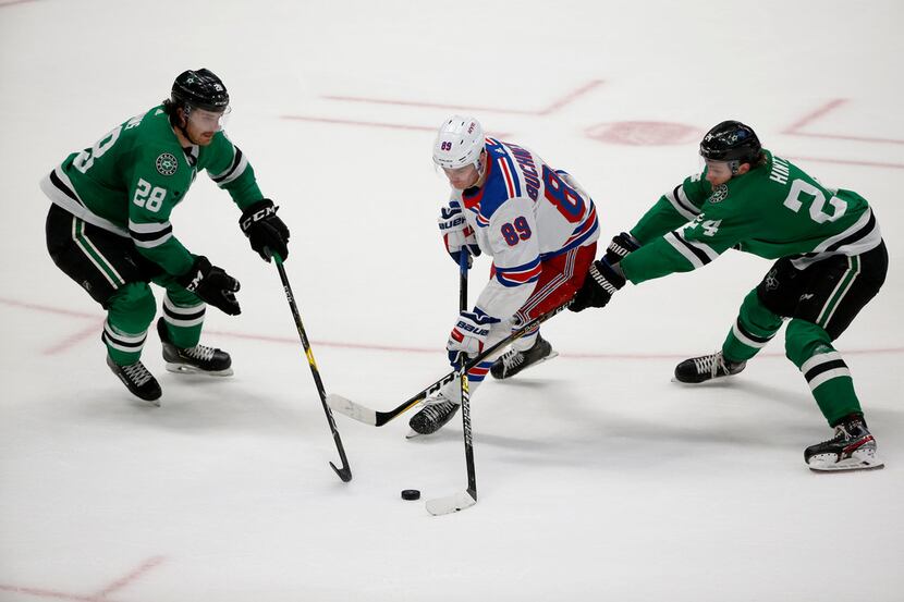 New York Rangers right wing Pavel Buchnevich (89) tries to get the puck past Dallas Stars...