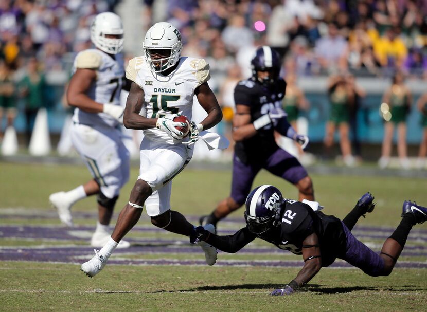 FILE - Baylor wide receiver Denzel Mims (15) evades a tackle from TCU cornerback Jeff...