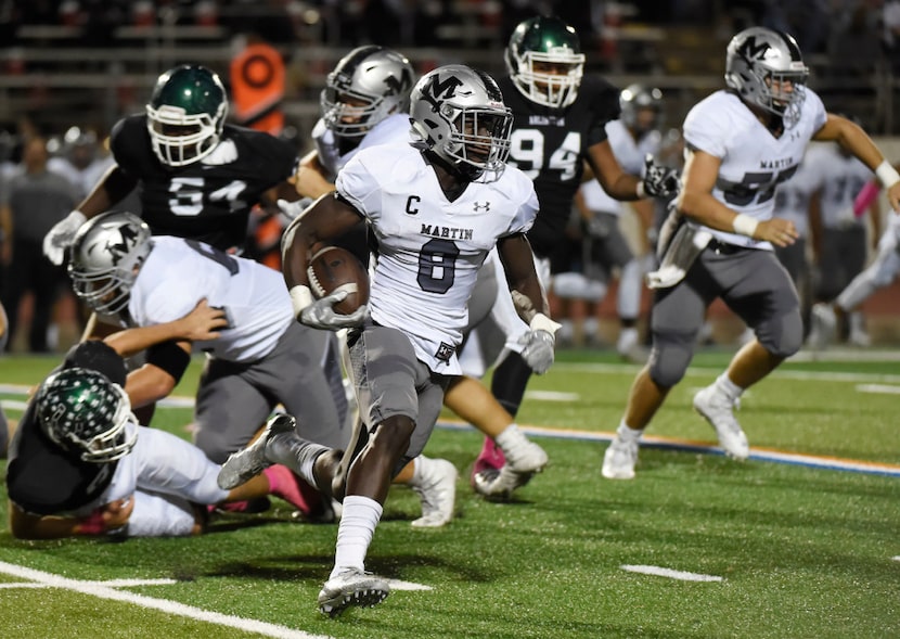 Arlington Martin's Juma Otoviano (8) runs against Arlington during their high school...