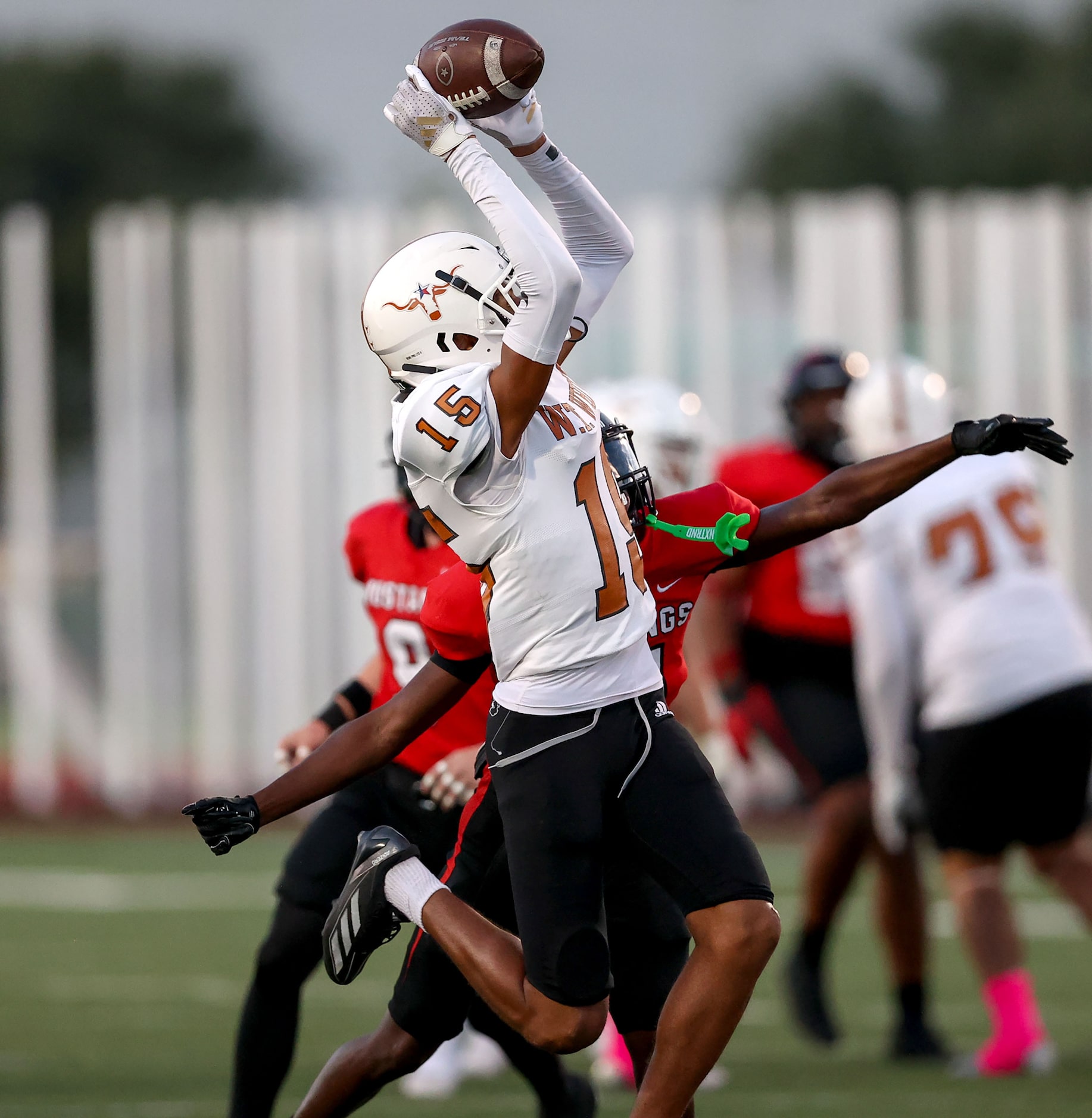 W.T. White wide receiver Lovell Neal (15) comes up with a nice reception against Creekview...