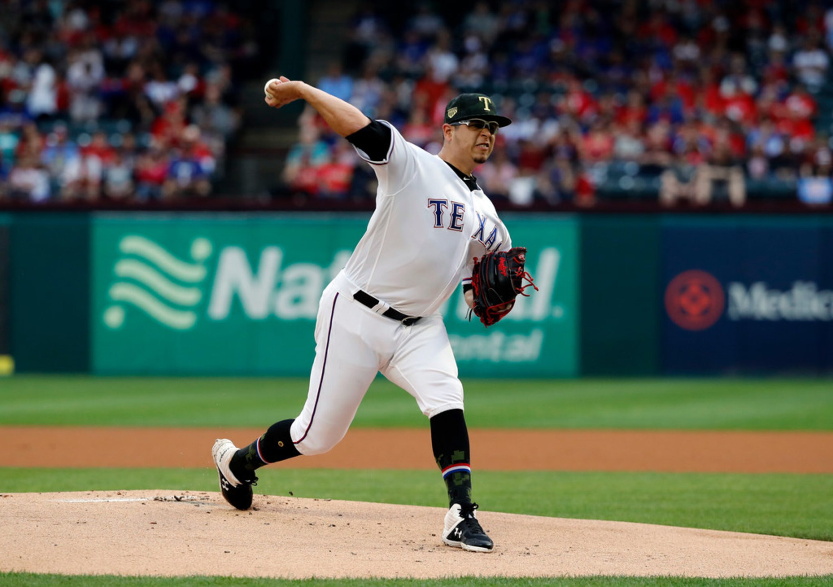 Texas Rangers starting pitcher Ariel Jurado throws to the St. Louis Cardinals in the first...