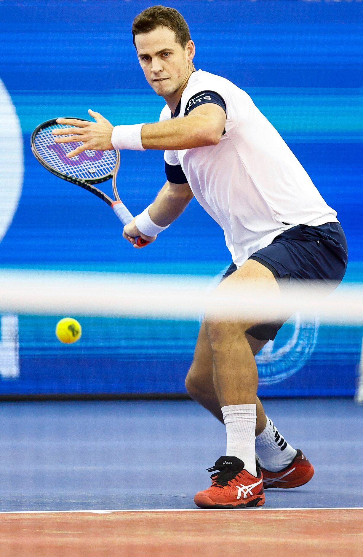 Vasek Pospisil returns the ball in a match against SMU senior Caleb Chakravarthi during the...