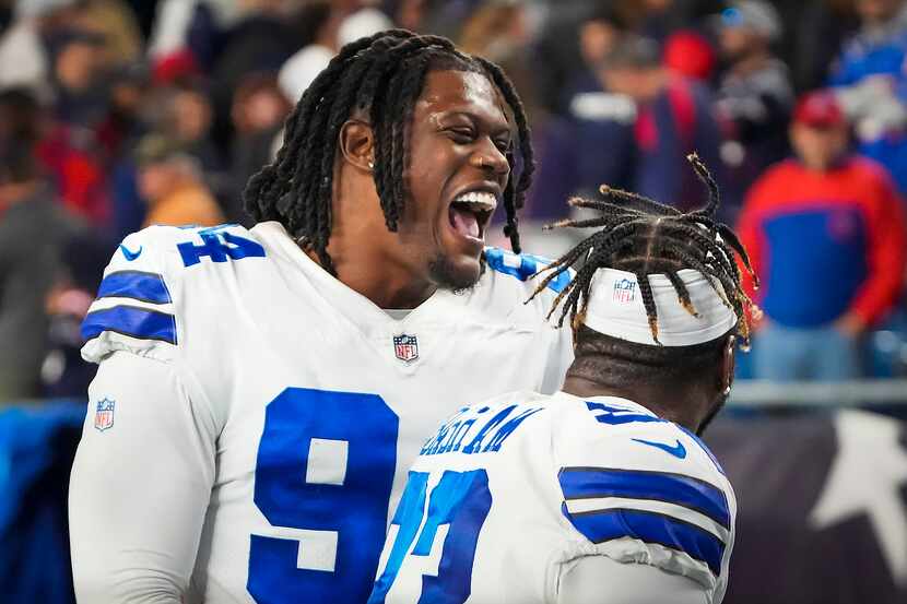 Dallas Cowboys defensive end Randy Gregory (94) celebrates with defensive end Tarell Basham...