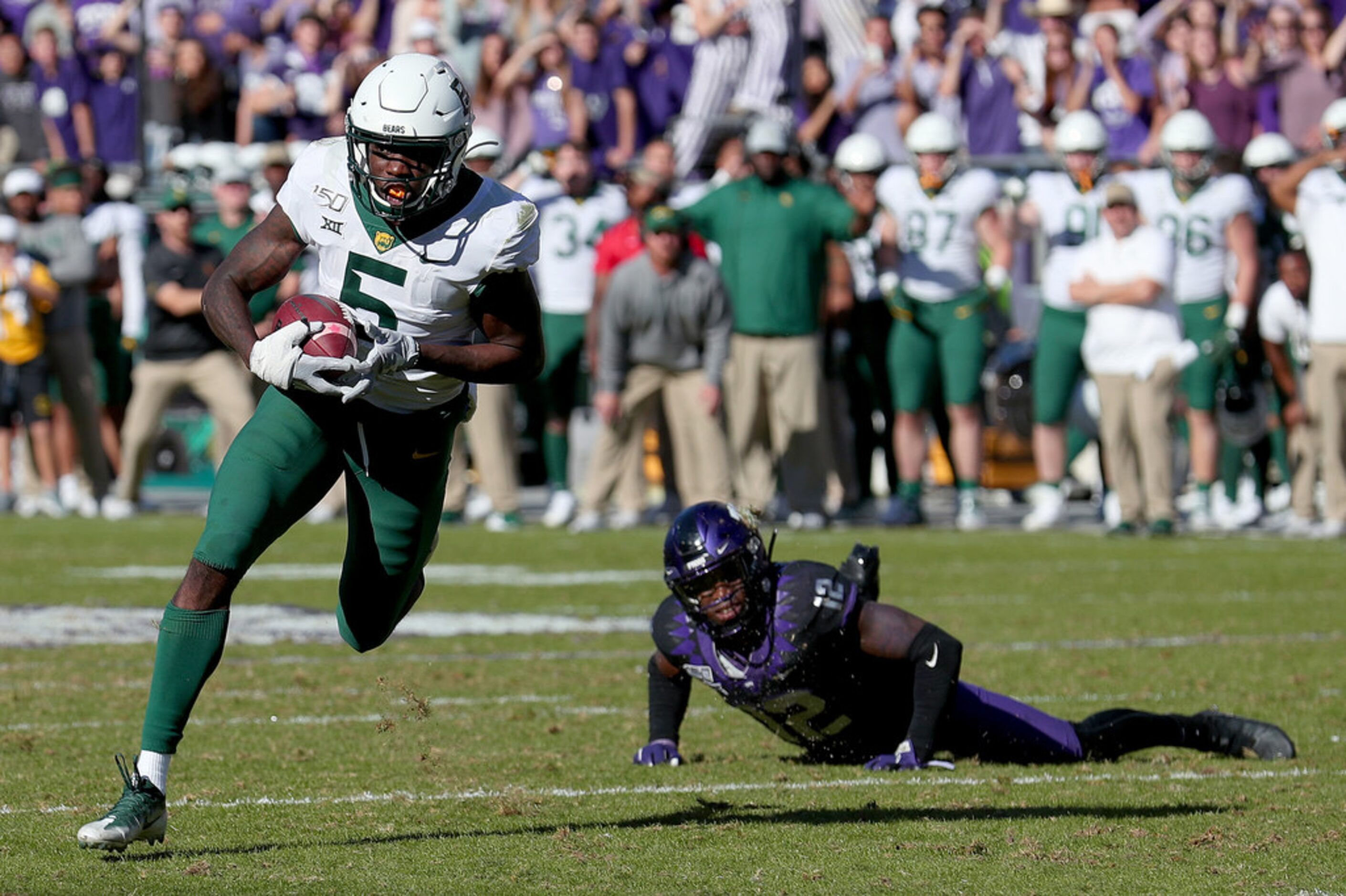 Baylor wide receiver Denzel Mims (5) scores on a 20-yard touchdown catch as a fallen Jeff...