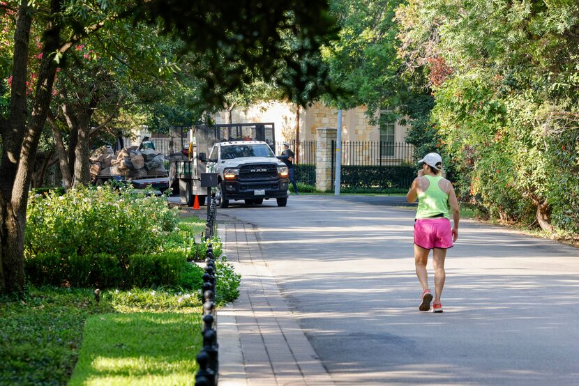 A woman walks along Hathaway Street, where a home hosting this year's Kips Bay Decorator...