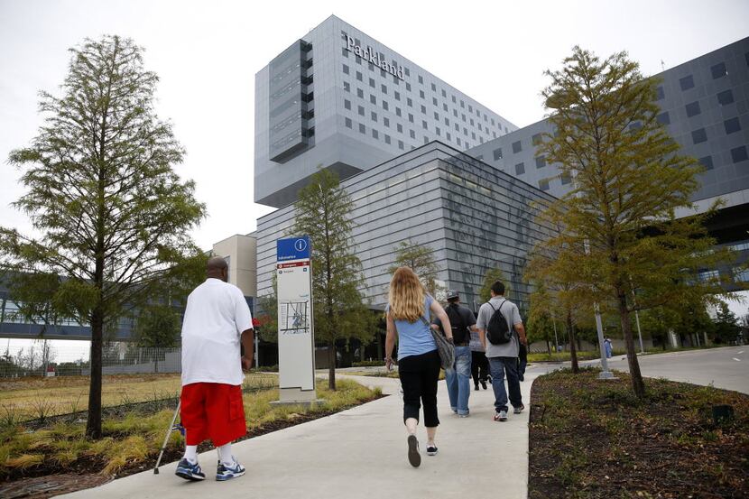 Fredrick Bowers of Dallas (left) slowly makes his way to the Emergency room of the new...