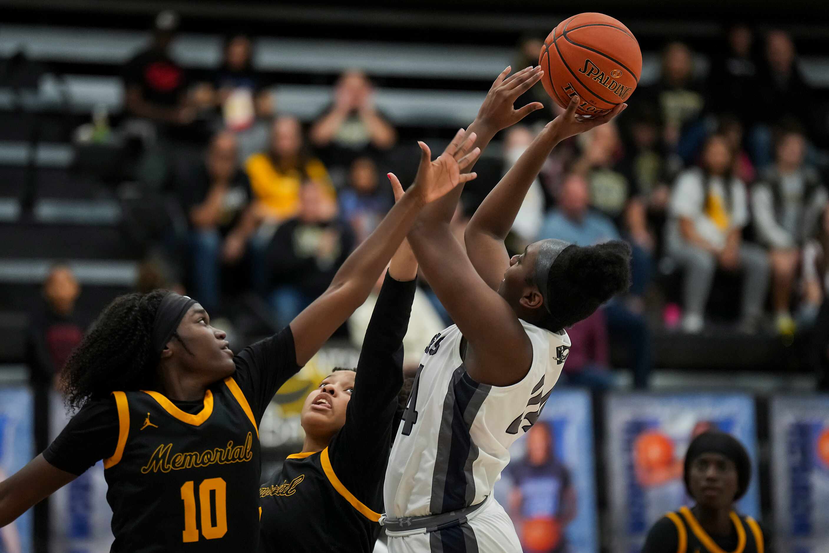 Frisco Memorial's Ja'dyn McDonald (24) puts up a shot as Frisco Memorial's Jasmyn Lott (10)...