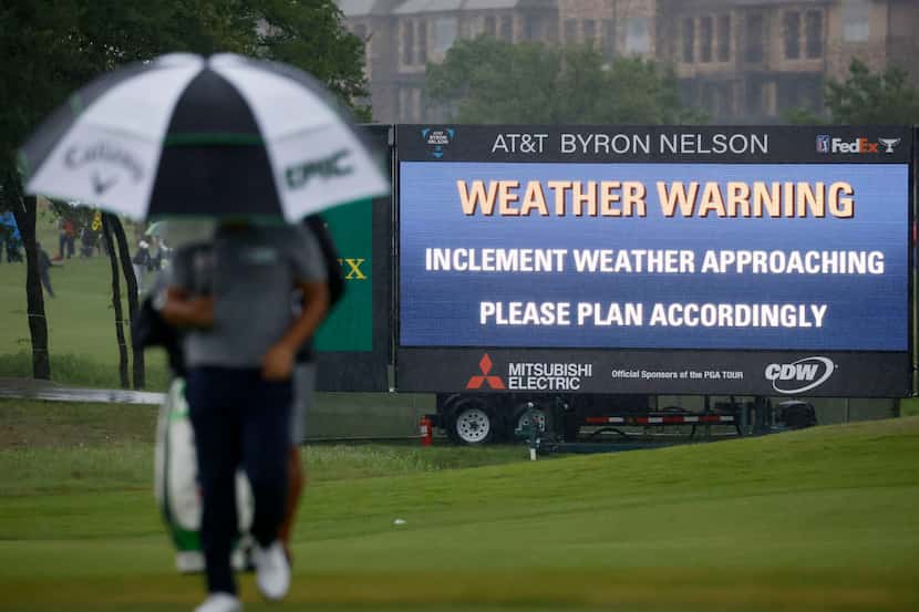Kyoung-Hoon Lee walks the green on the 9th hole as it rains during round 4 of the AT&T Byron...