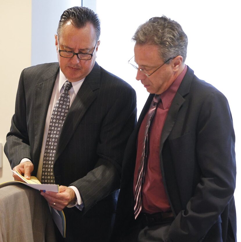 Board member Rick Salinas, left, talks with George Tomasovic, chairman of the board of the...