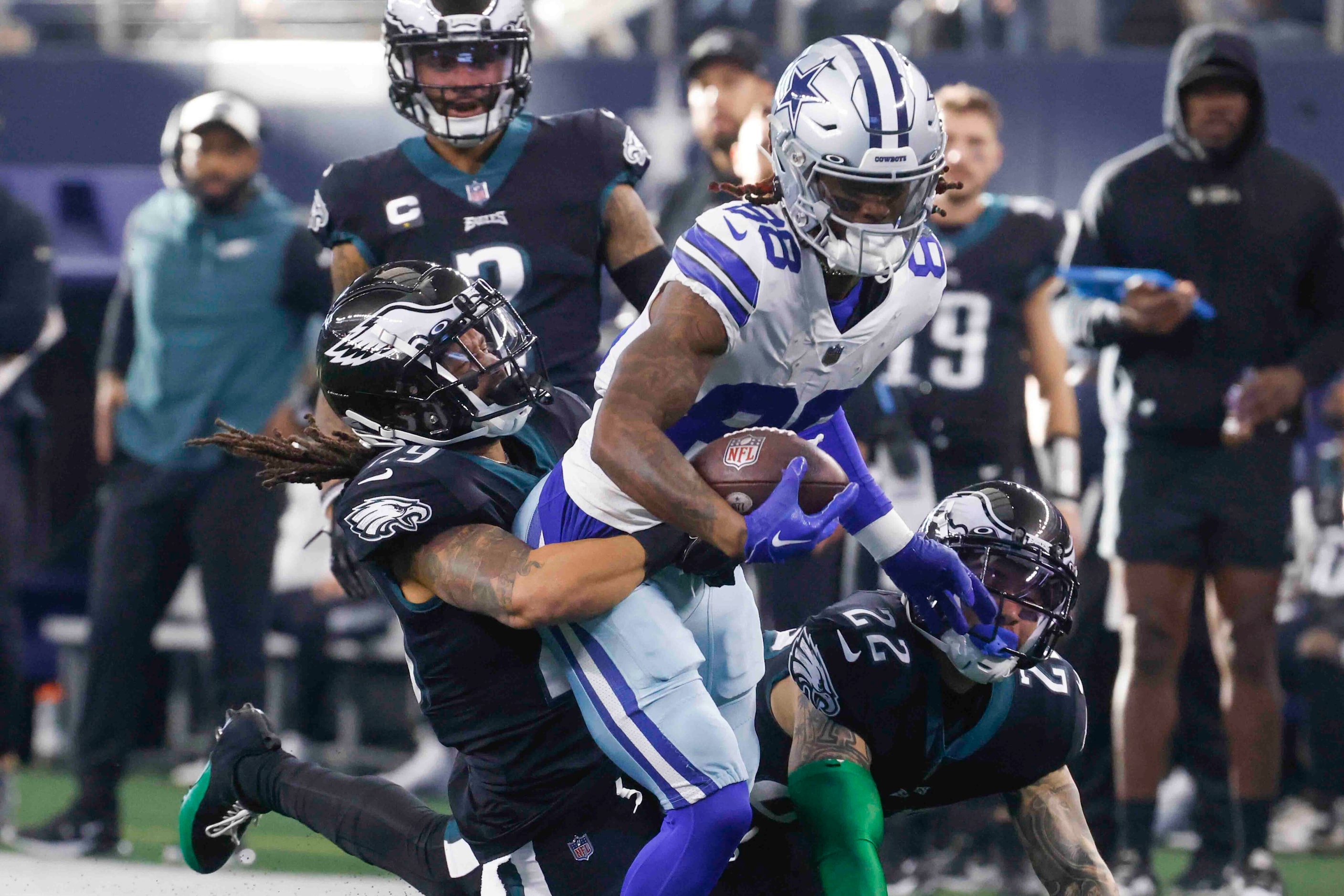 Dallas Cowboys wide receiver CeeDee Lamb (88), center, gets tackled by Philadelphia Eagles...