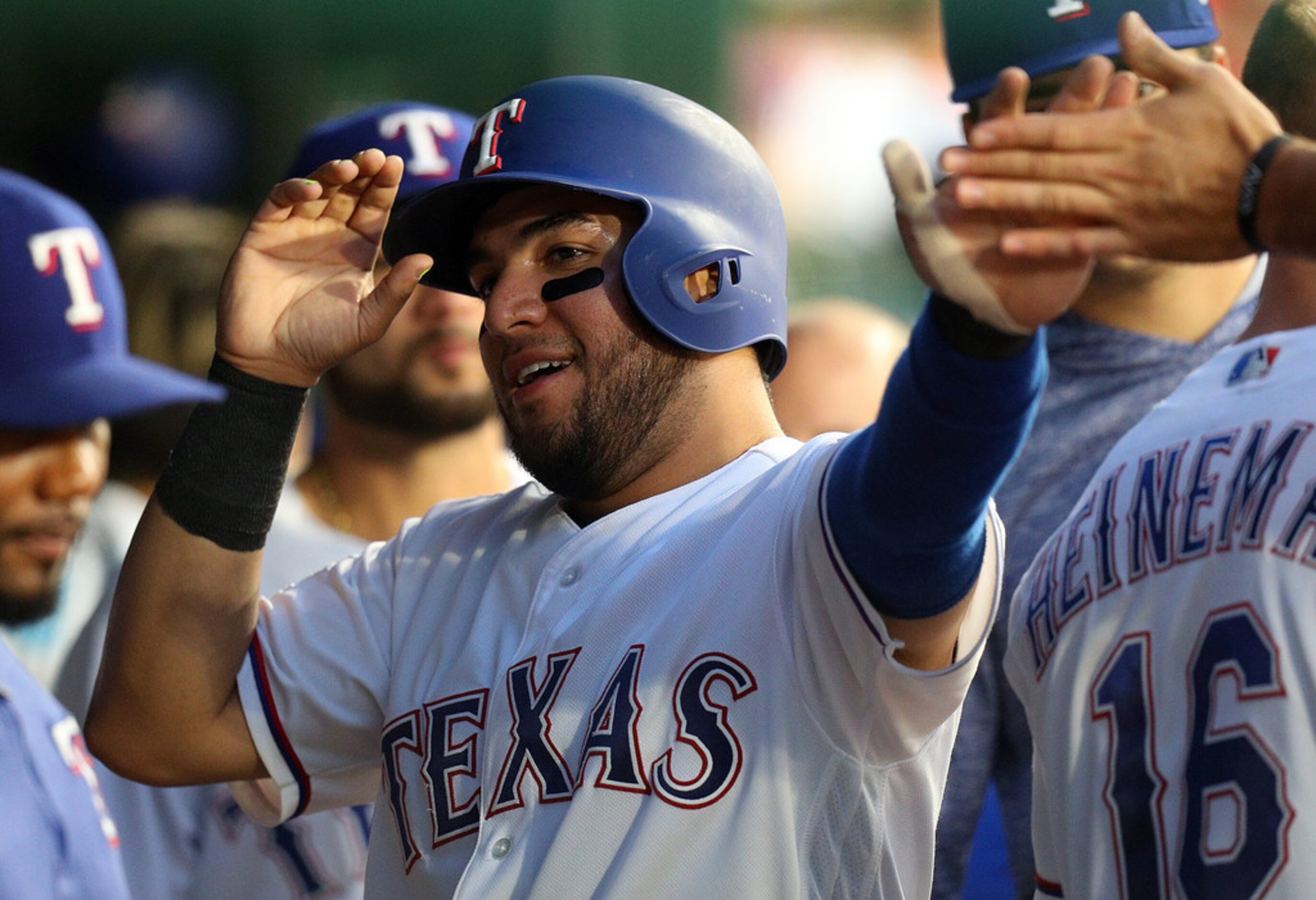 ARLINGTON, TEXAS - AUGUST 30: Jose Trevino #56 of the Texas Rangers is greeted in the dugout...