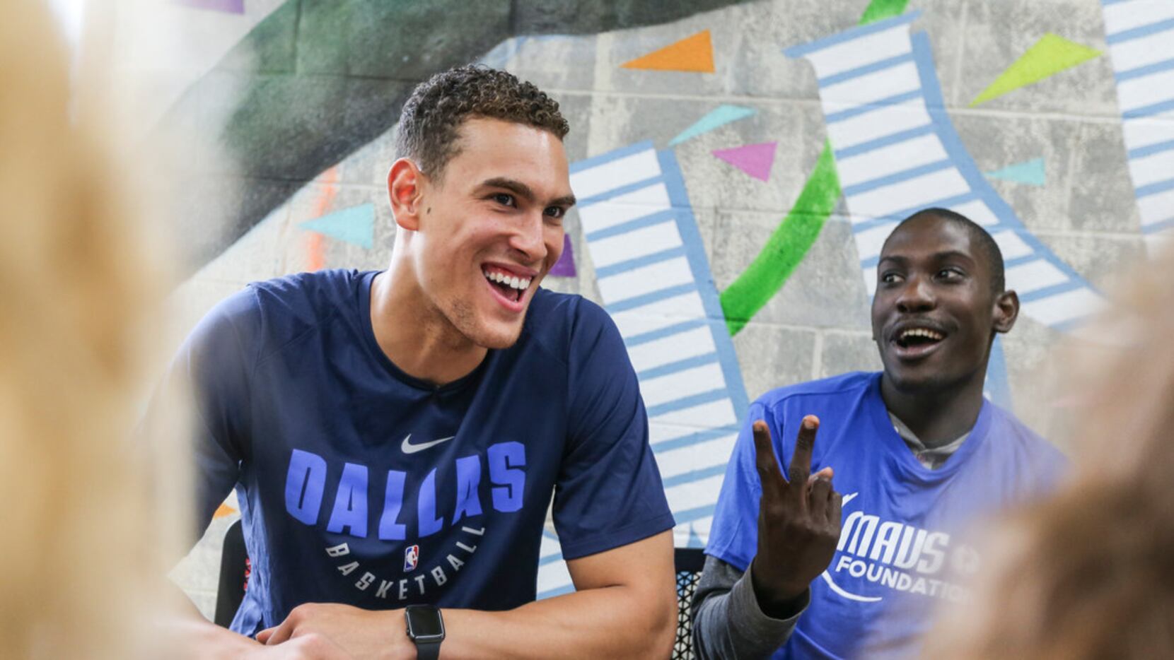 Dwight Powell (left) jokes with John Callaway, of Dallas, as the Mavs Foundation, the...