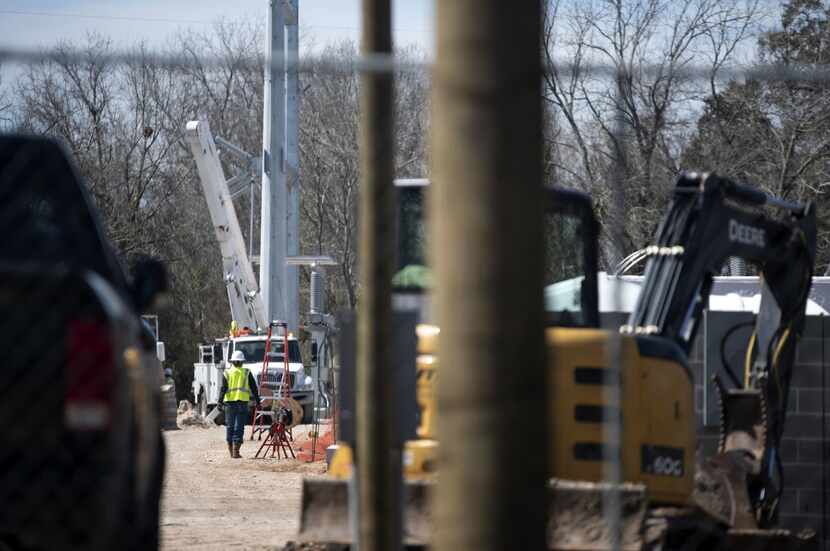 A contractor walks through the Gambit Energy Storage Park under construction in Angleton on...