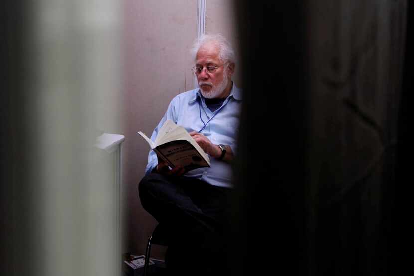 In this 2012 file photo, Michael Ondaatje reads at the back stage green room before...