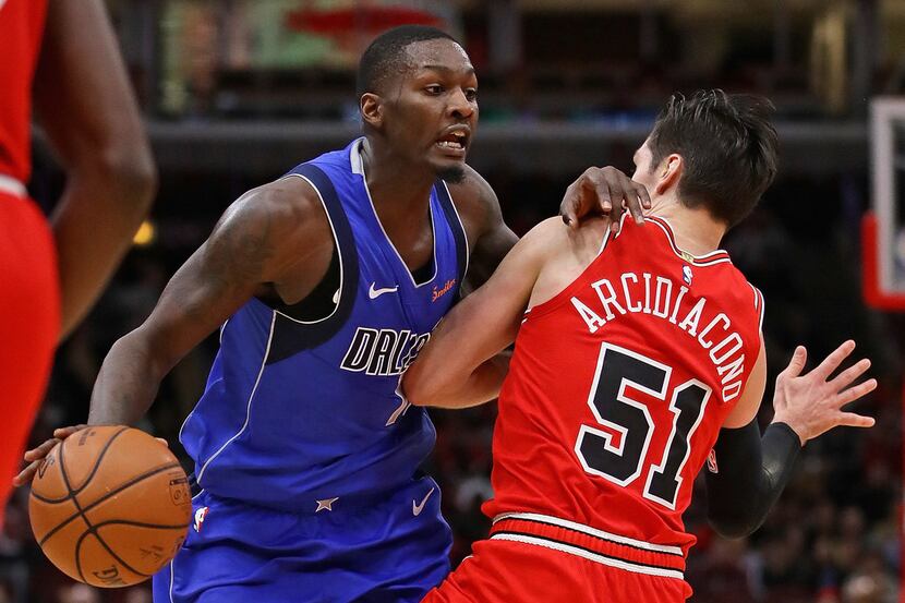 CHICAGO, IL - NOVEMBER 12:  Dorian Finney-Smith #10 of the Dallas Mavericks is fouled by...