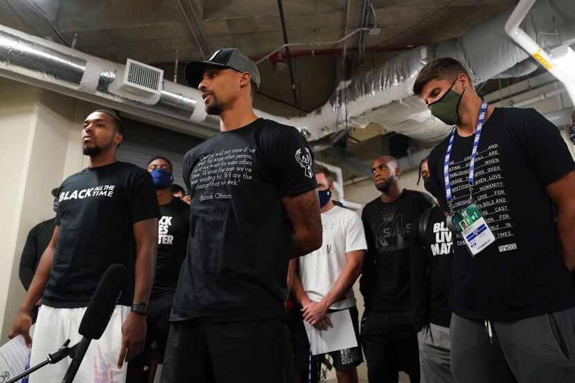 ORLANDO, FL - AUGUST 26: Sterling Brown (far left) and George Hill (2nd from left) of the...