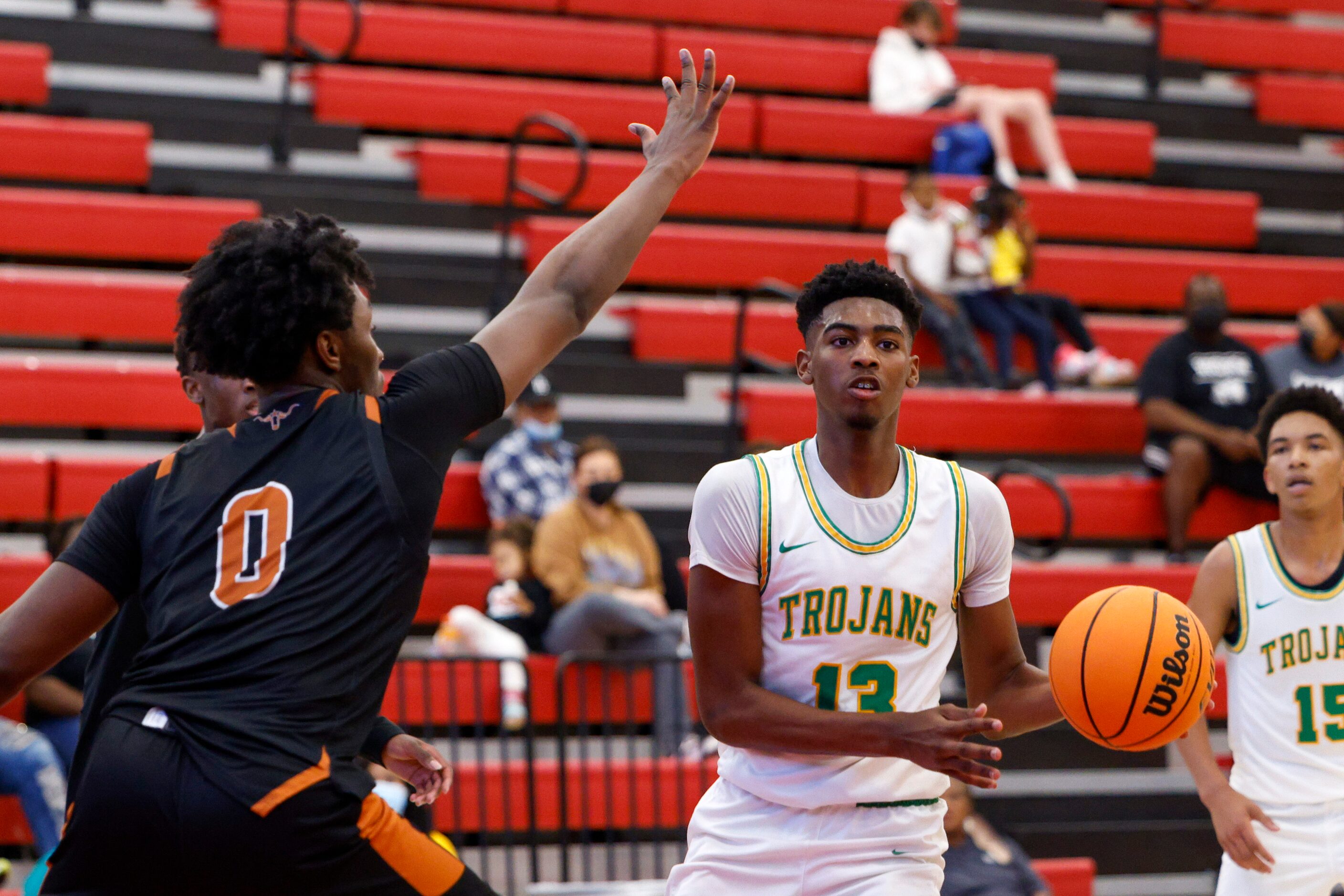 Madison forward Quintin Spencer (13) passes the ball around W.T. White forward Dre Cole (0)...