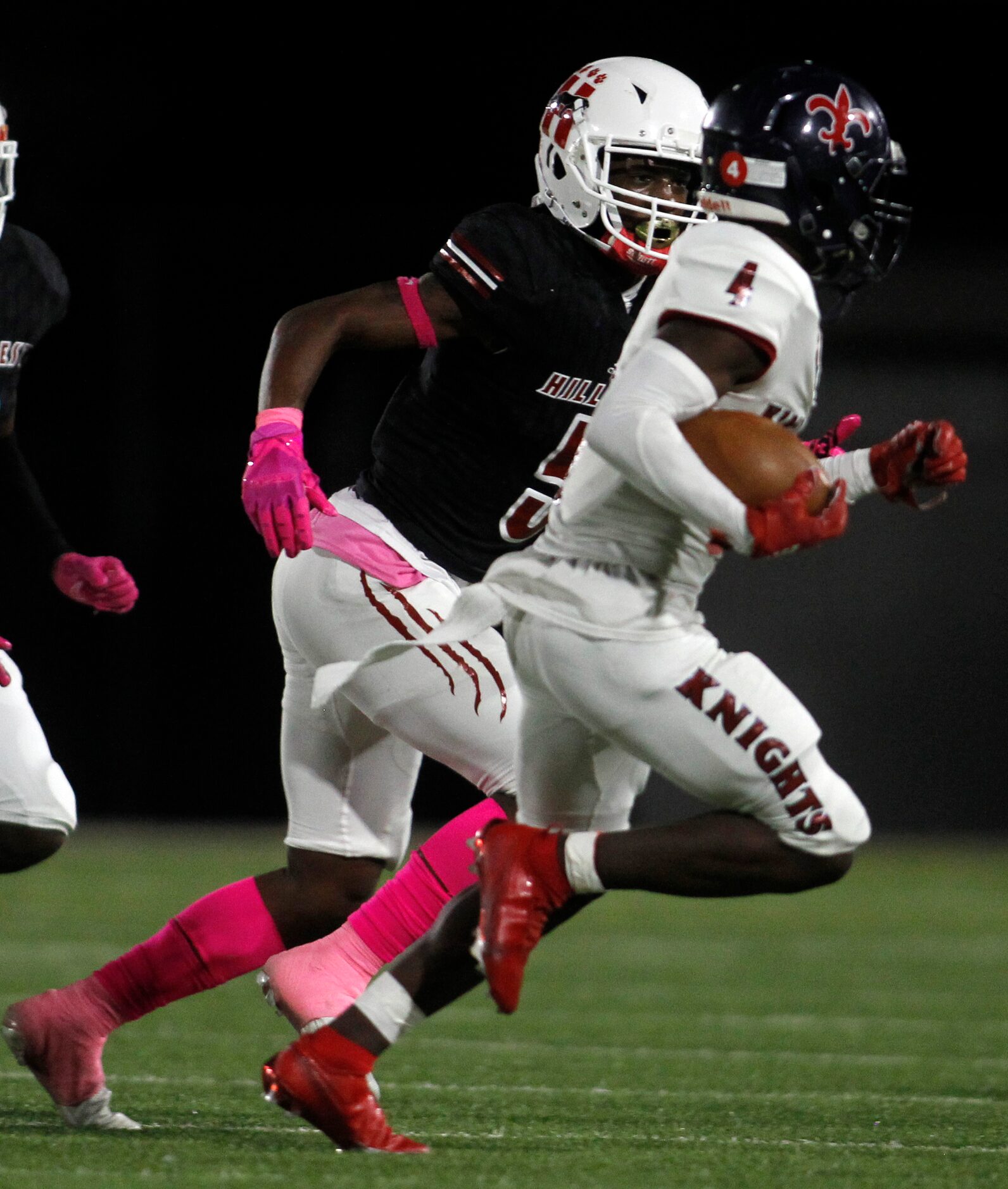 Dallas Kimball running back Niteroi Davis (4), right, looks for running room as he is...