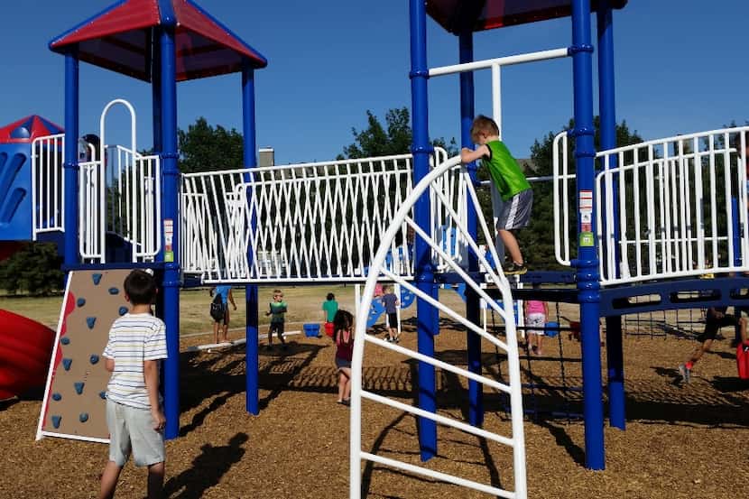  Students at Bright Elementary School check out the new playground equipment during a...