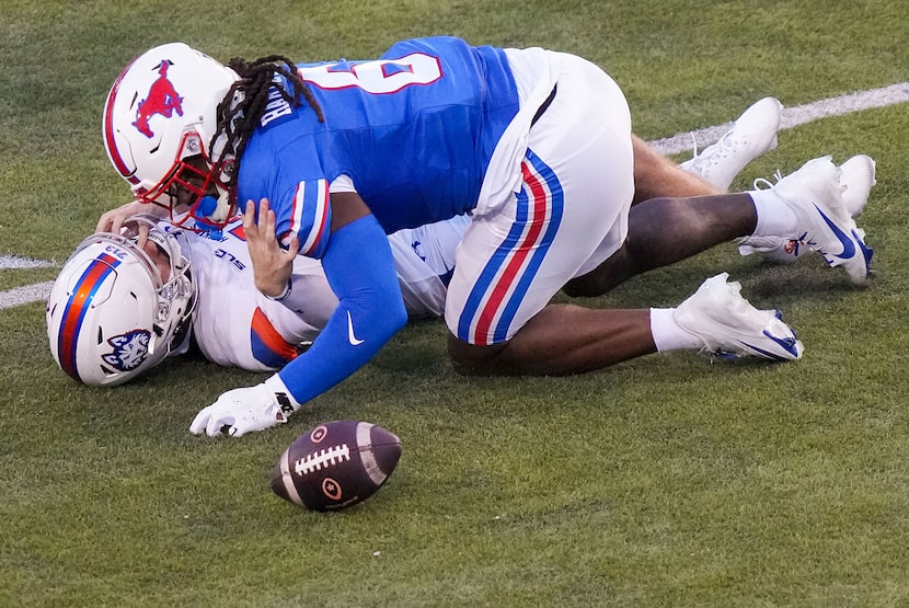 Houston Christian quarterback CJ Rogers (12) fumbles as he is hit by SMU defensive end...