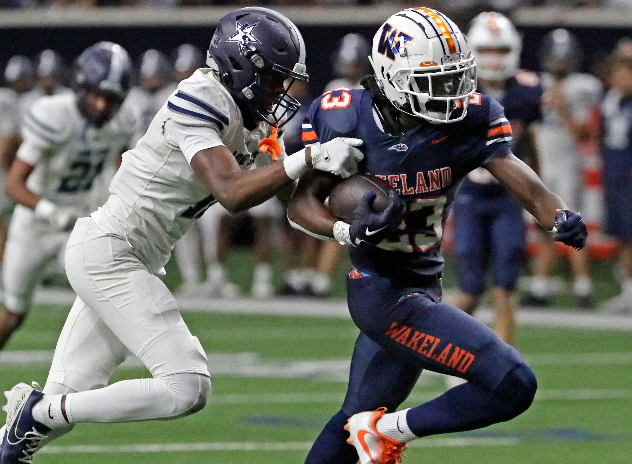 Wakeland High School wide receiver Lucas Mangham (23) makes a catch and gets behind Lone...