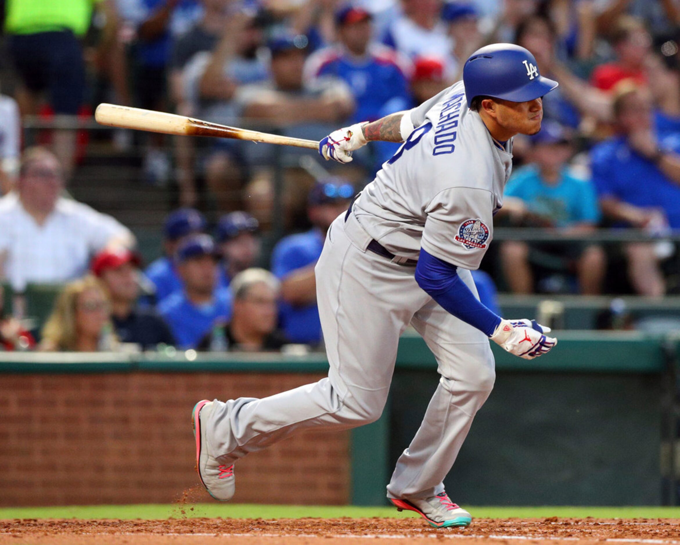 Los Angeles Dodgers' Manny Machado (8) follows through on a two-run single in the third...