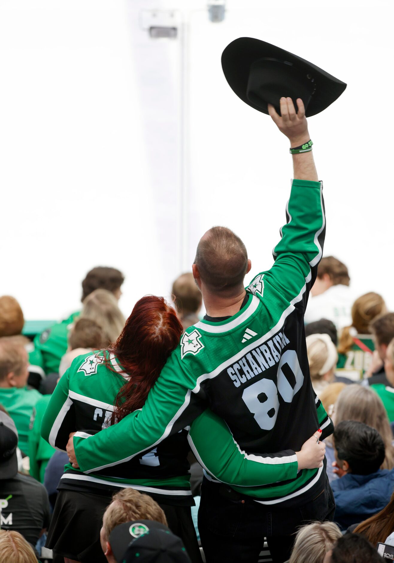 Dallas Stars fans dance to country music played during a third period timeout at the...