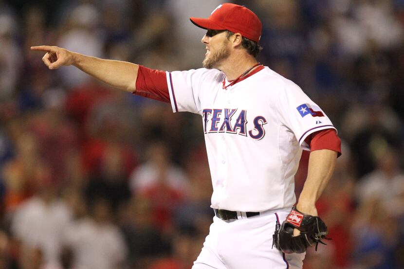 Texas closer Joe Nathan gestures to the home plate umpire as he pitches in the ninth inning...
