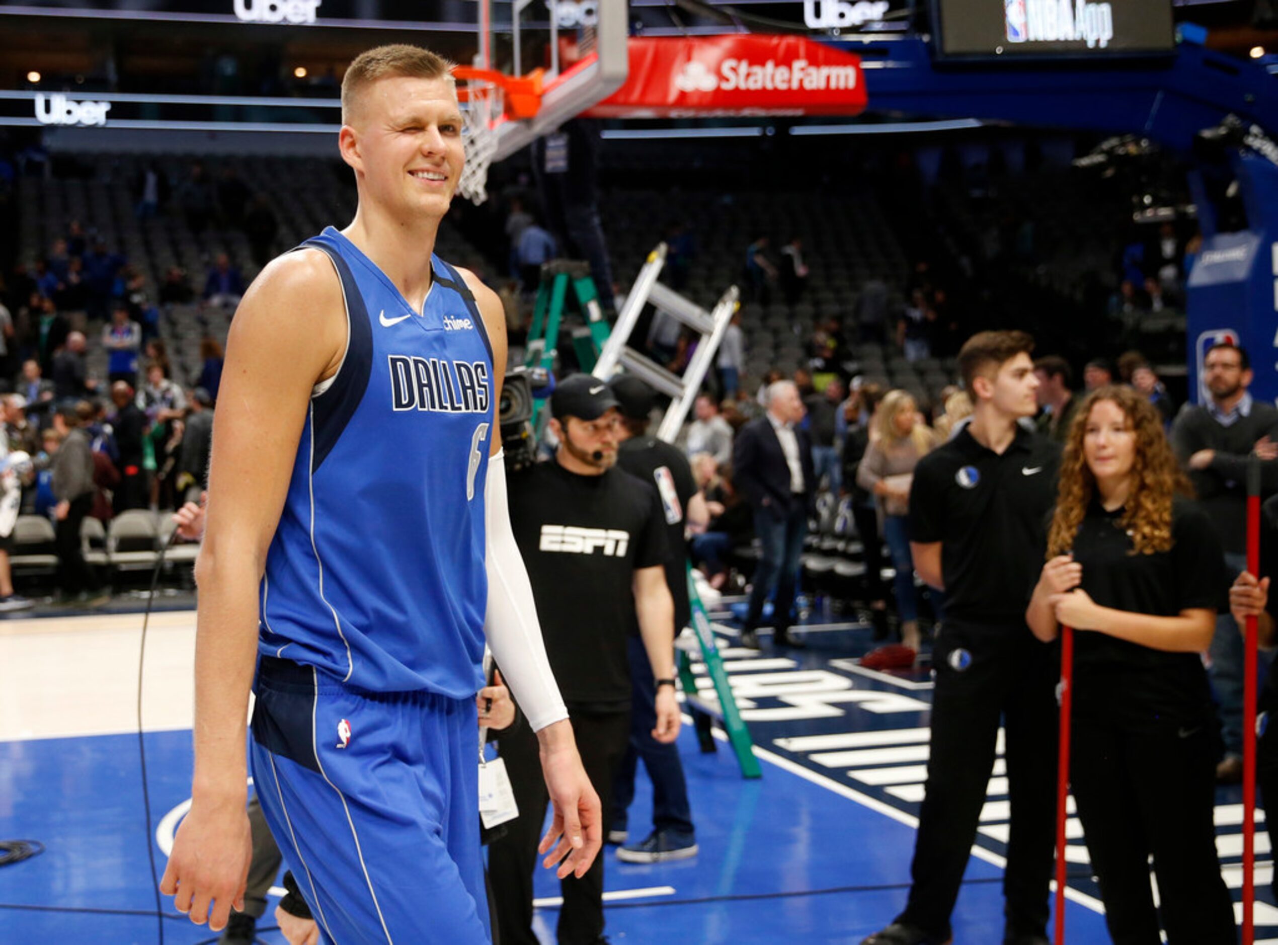 Dallas Mavericks forward Kristaps Porzingis (6) winks as he walks off the court after the...