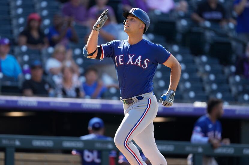 Texas Rangers' Nathaniel Lowe gestures as he circles the bases after hitting a three-run...