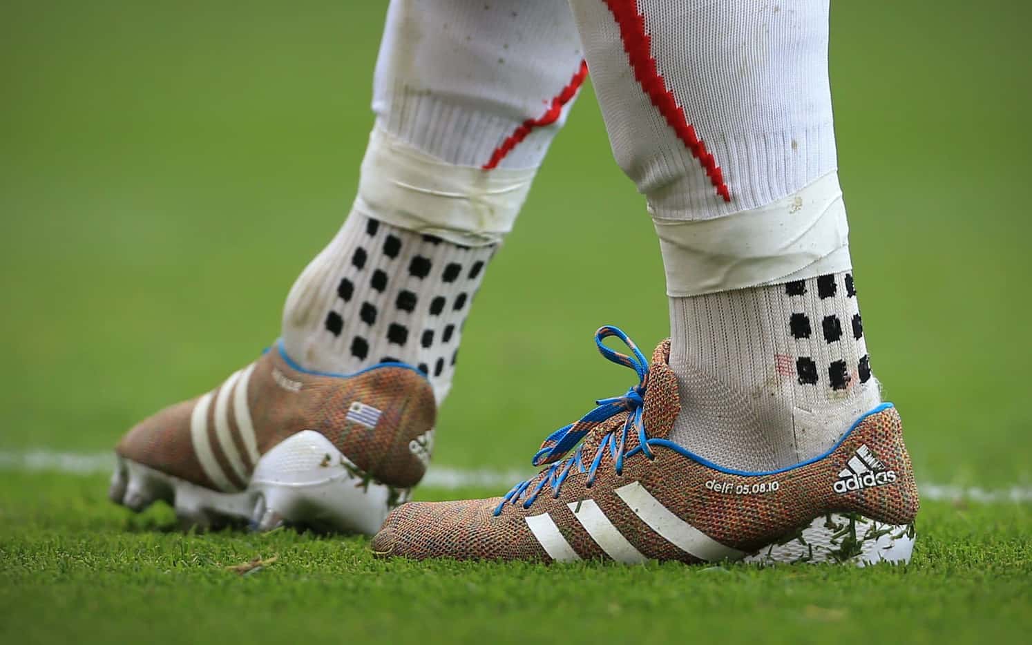 Luis Suarez wearing TRUsox while playing for Liverpool. The distinctive wet grip pattern is...