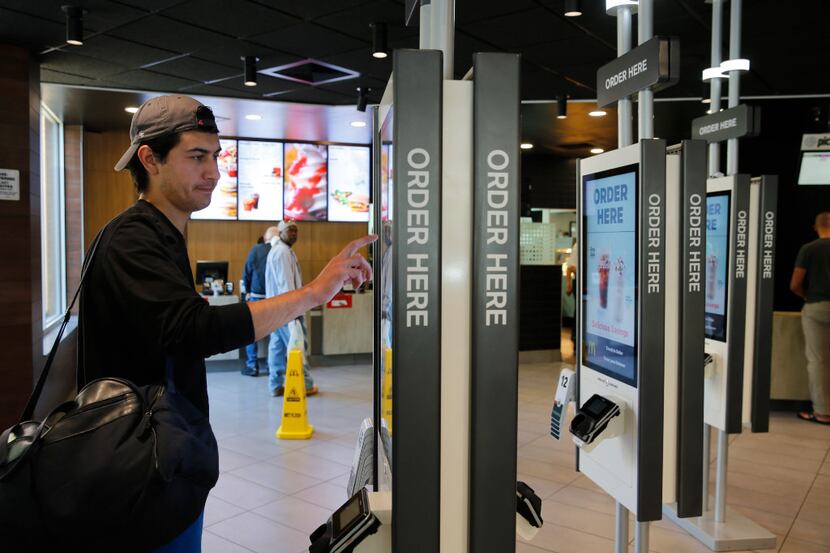 Brandon Alba orders food at a self-service kiosk at a McDonald's restaurant in Chicago....