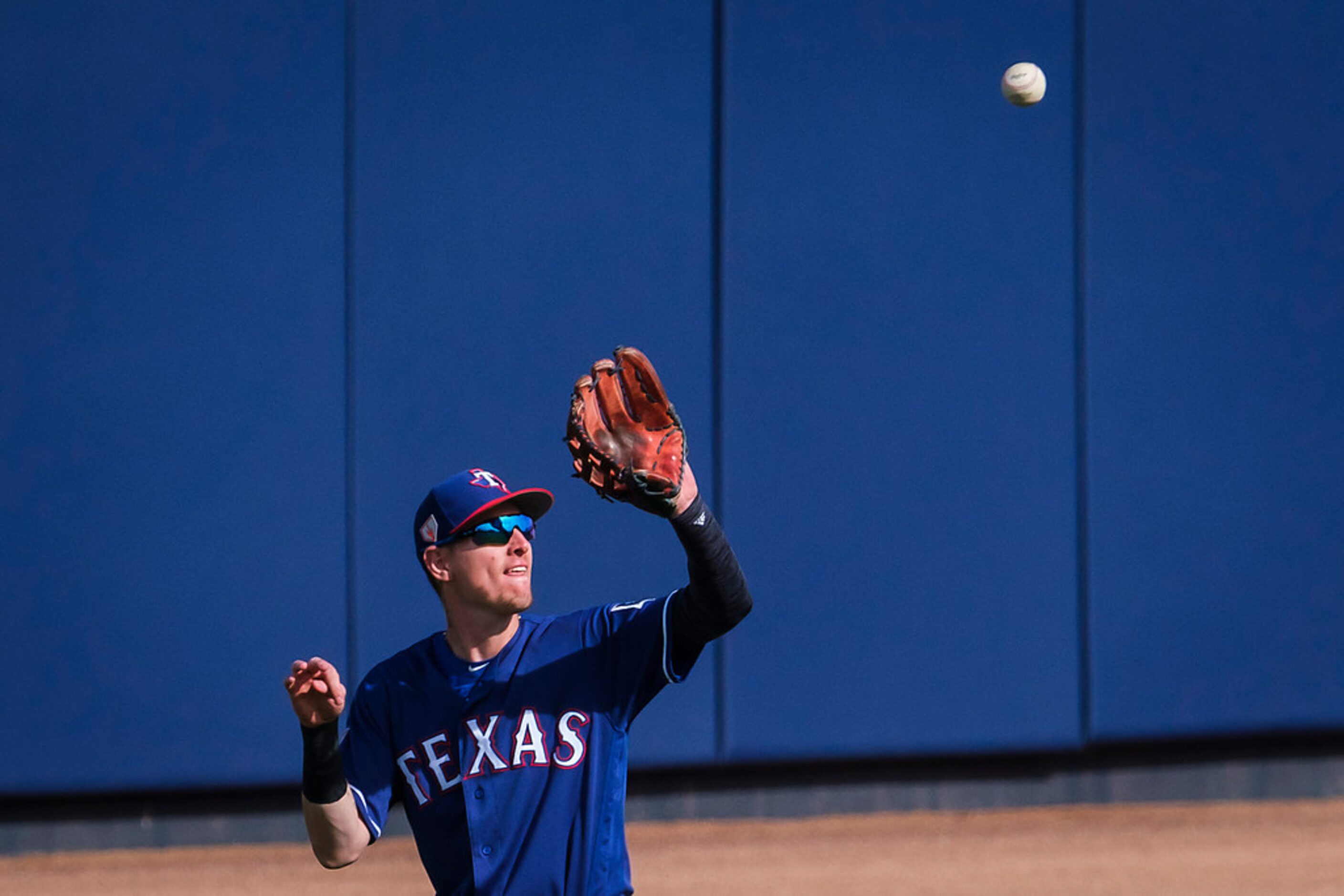 Texas Rangers outfielder Carlos Tocci hauls in a fly ball of the bat of Seattle Mariners...