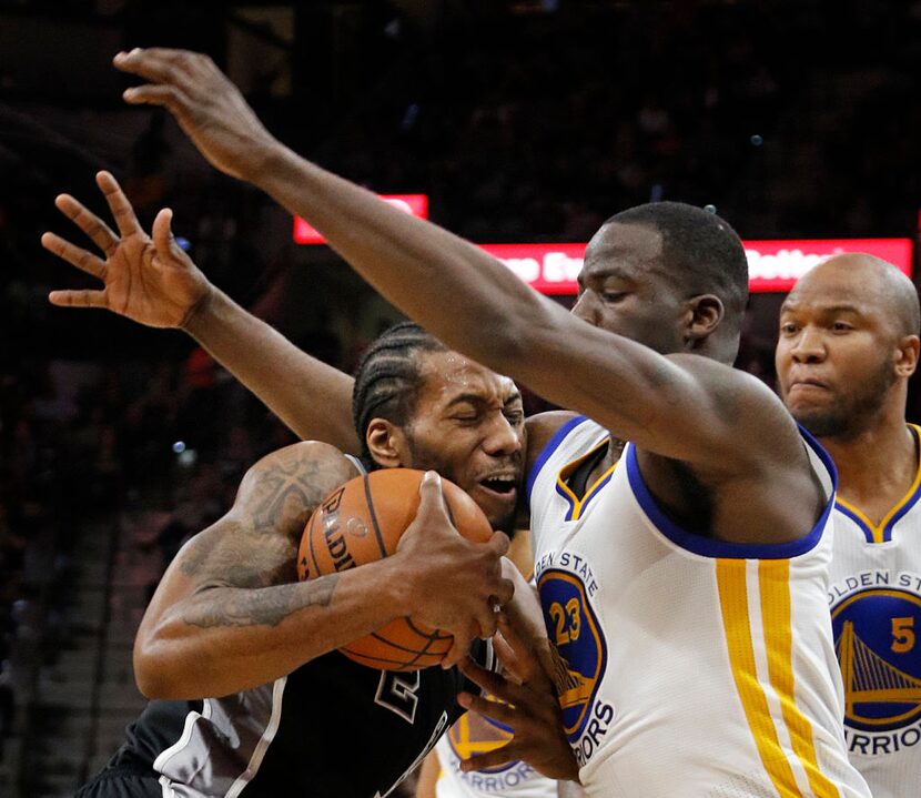 San Antonio's Kawhi Leonard (left)  oand Golden State's Draymond Green.