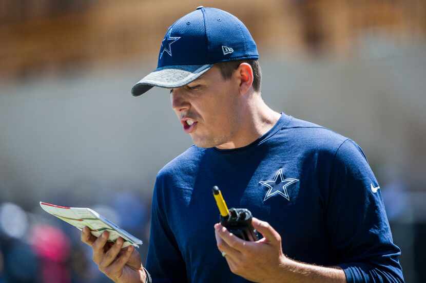 Dallas Cowboys offensive coordinator Kellen Moore calls a play during a morning practice at...