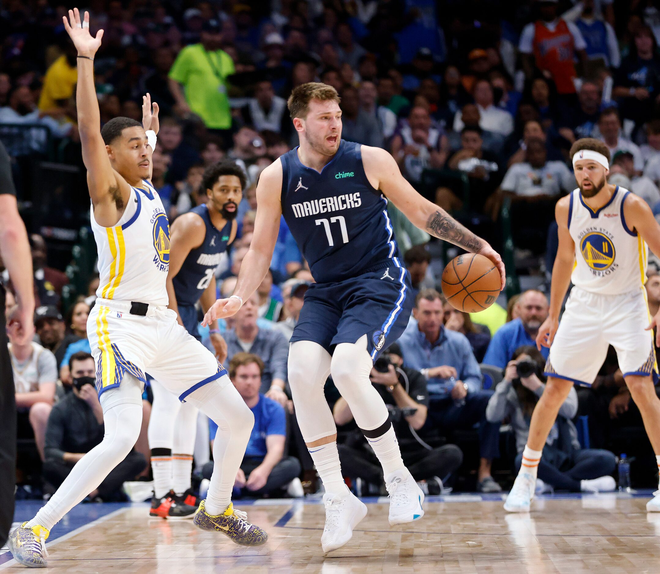 Dallas Mavericks guard Luka Doncic (77) spins away from Golden State Warriors guard Jordan...