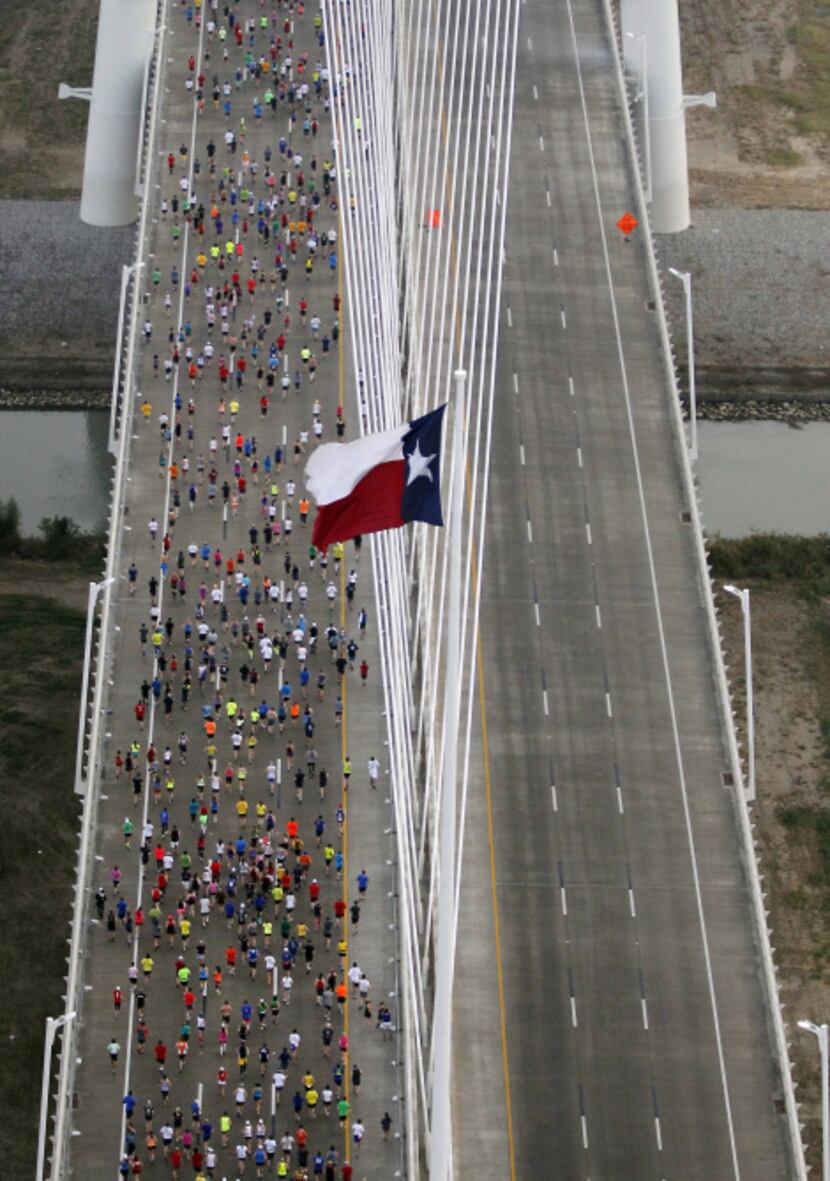 Runners make their across the Margaret Hunt Hill Bridge during the MetroPCS Dallas Marathon...