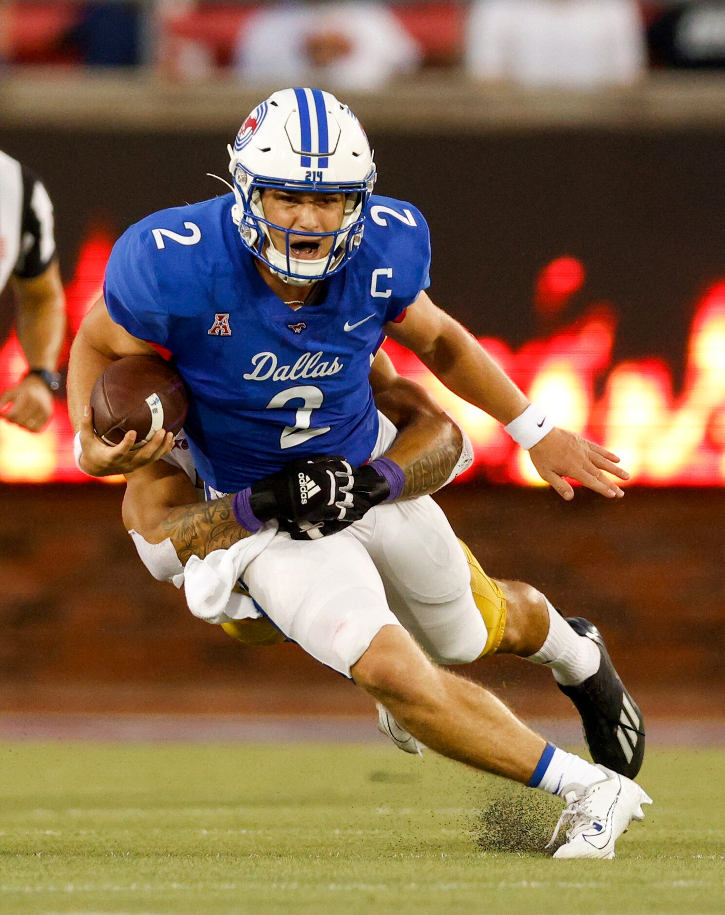 SMU quarterback Preston Stone (2) is brought down by a Prairie View A&M defender during the...