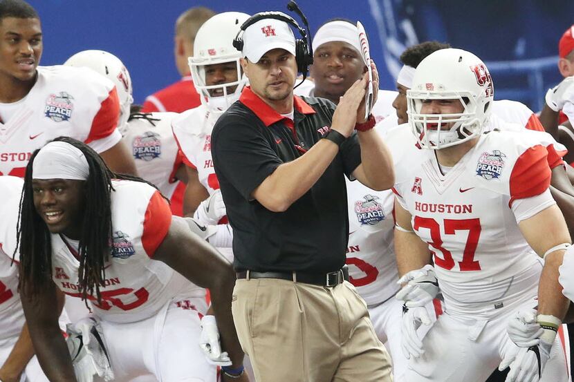 FILE - In this Dec. 31, 2015, file photo, Houston head coach Tom Herman watches play against...