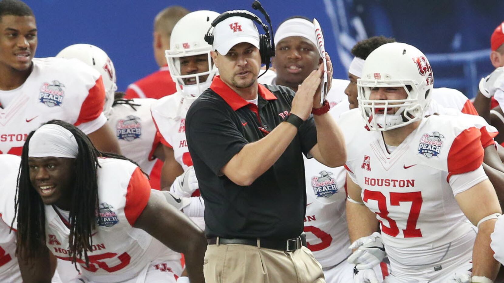 FILE - In this Dec. 31, 2015, file photo, Houston head coach Tom Herman watches play against...