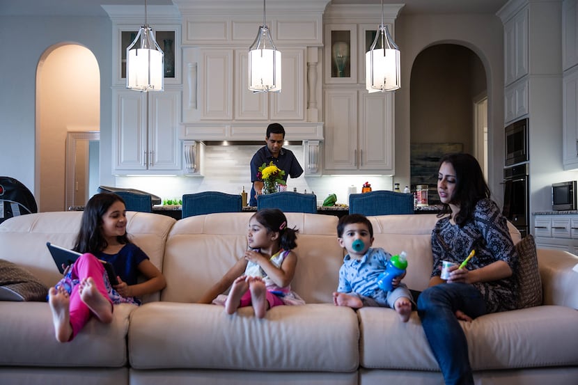 Naveed Khan cooks lunch for his wife, Ayesha, and children, Nazneen, 7, Yasmeen, 4, and...