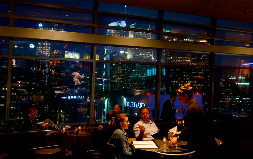 Guests dine with a stellar view of downtown Los Angeles at WP24 by Wolfgang Puck in the...