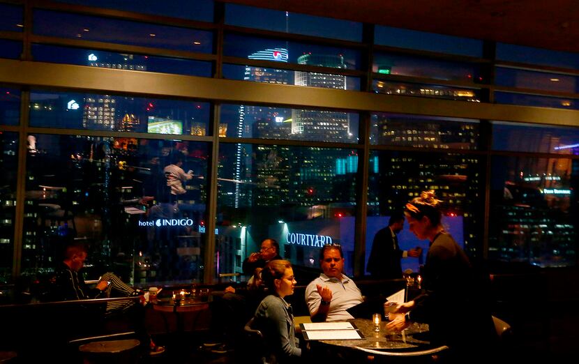 Guests dine with a stellar view of downtown Los Angeles at WP24 by Wolfgang Puck in the...