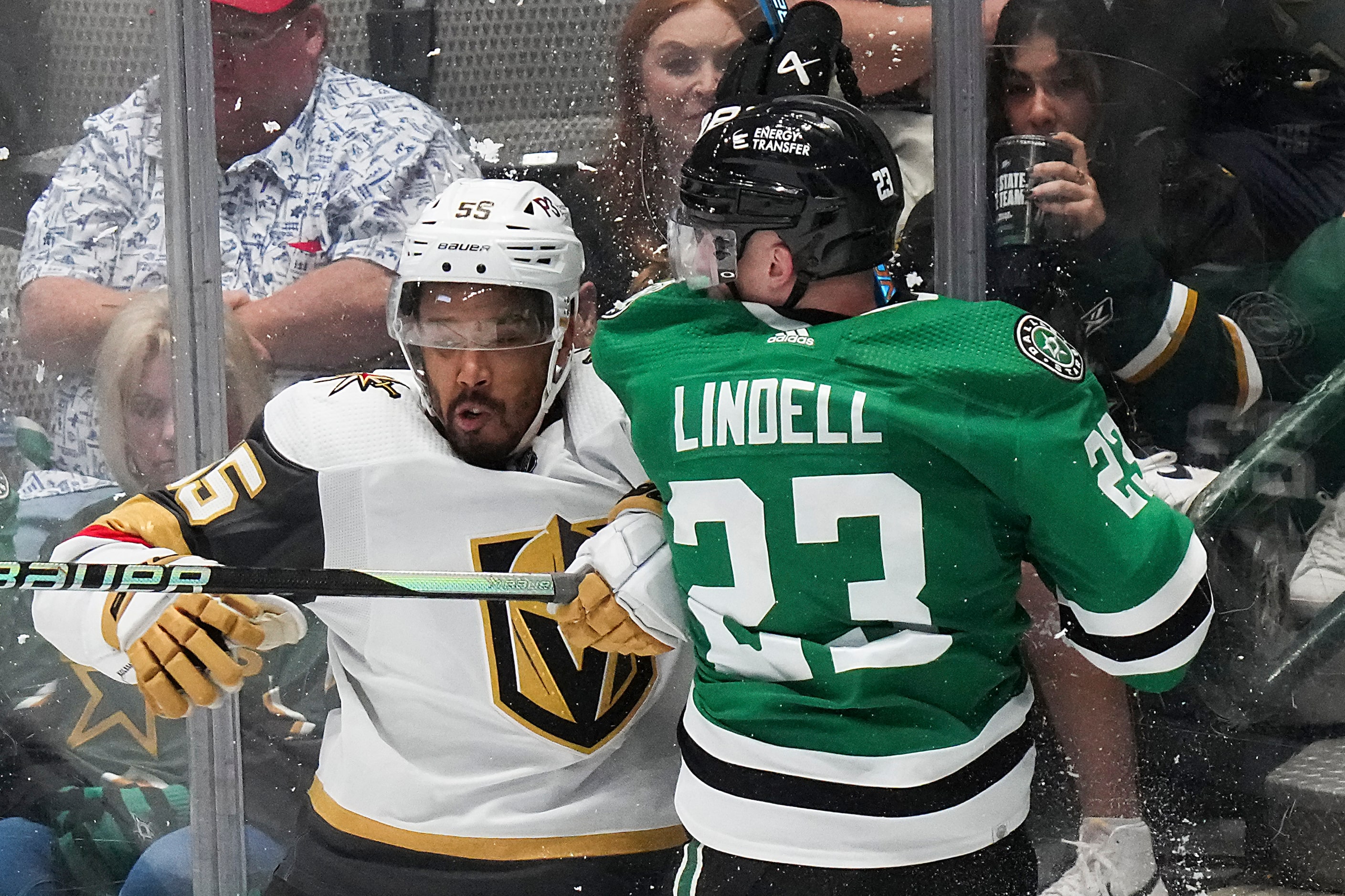 Dallas Stars defenseman Esa Lindell (23) is checked by Vegas Golden Knights right wing...