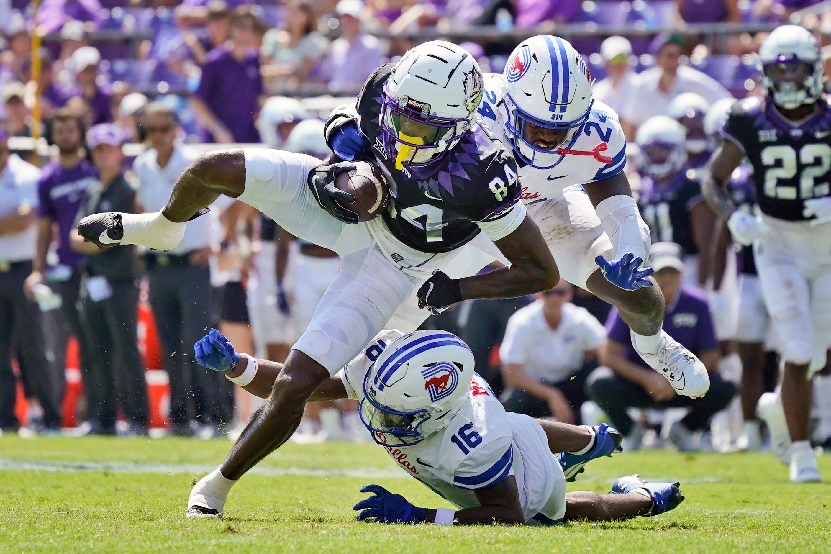 TCU wide receiver Warren Thompson (84) catches a pass against SMU defenders Ahmaad Moses...